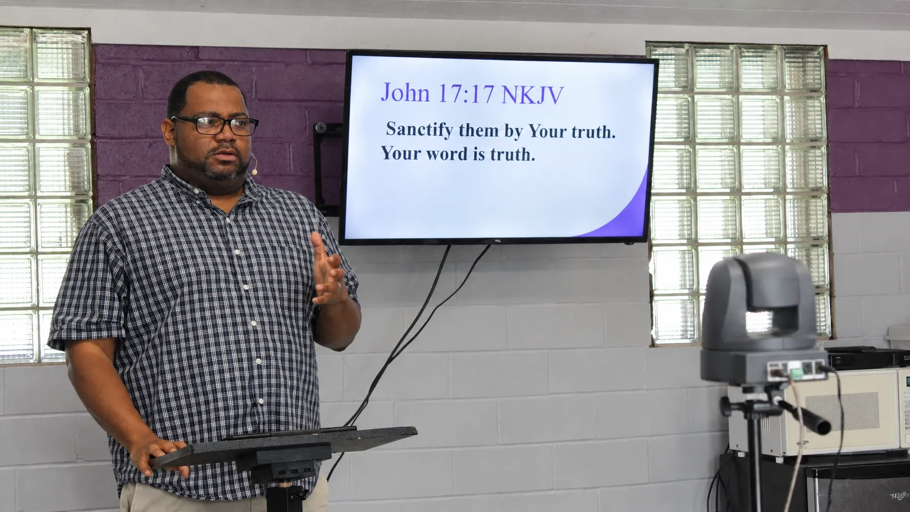 Dr. Shelton Tufts teaching from Scripture during a Sunday service